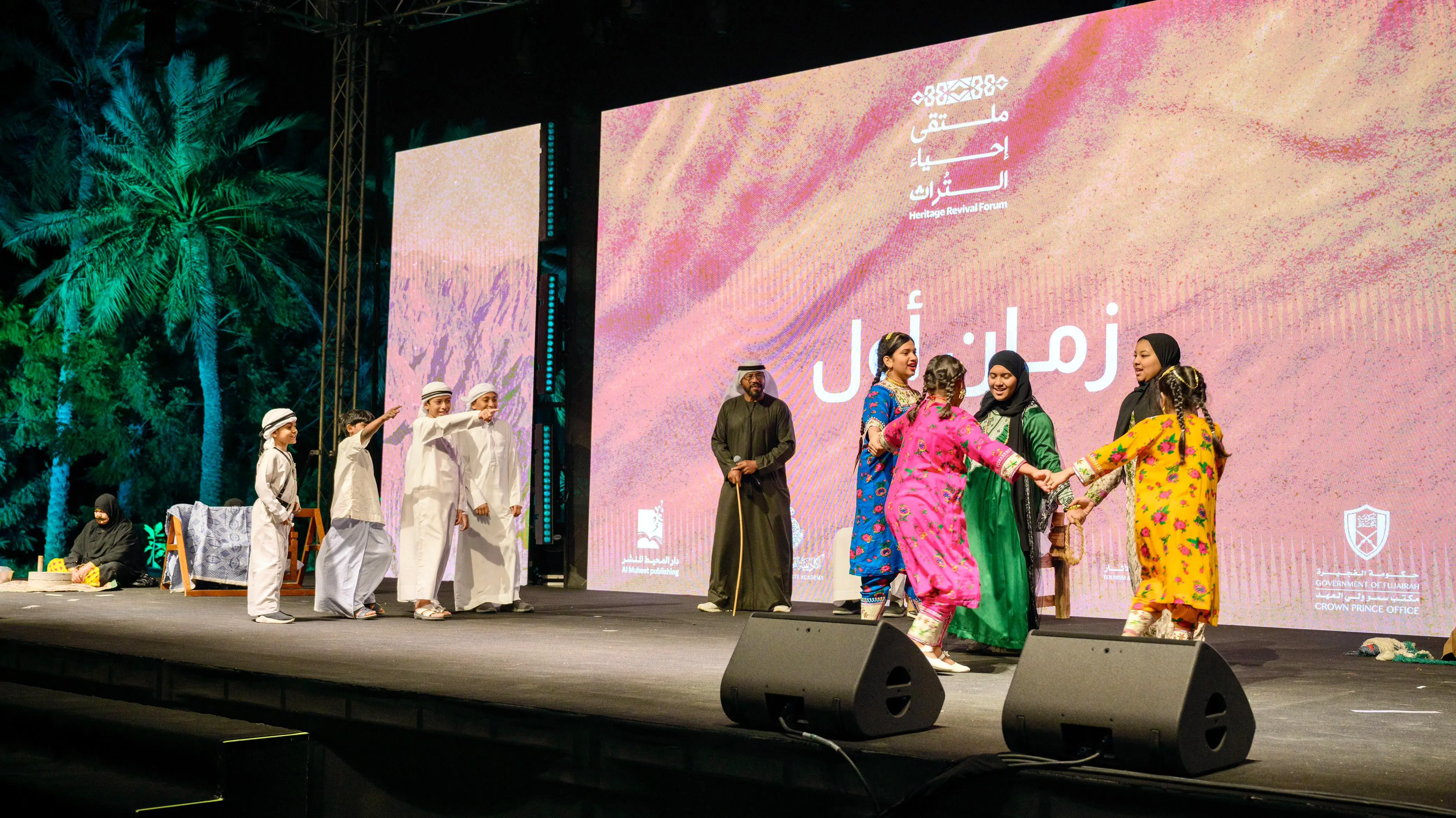 Stage performance at Heritage Revival Forum with children in traditional dress
