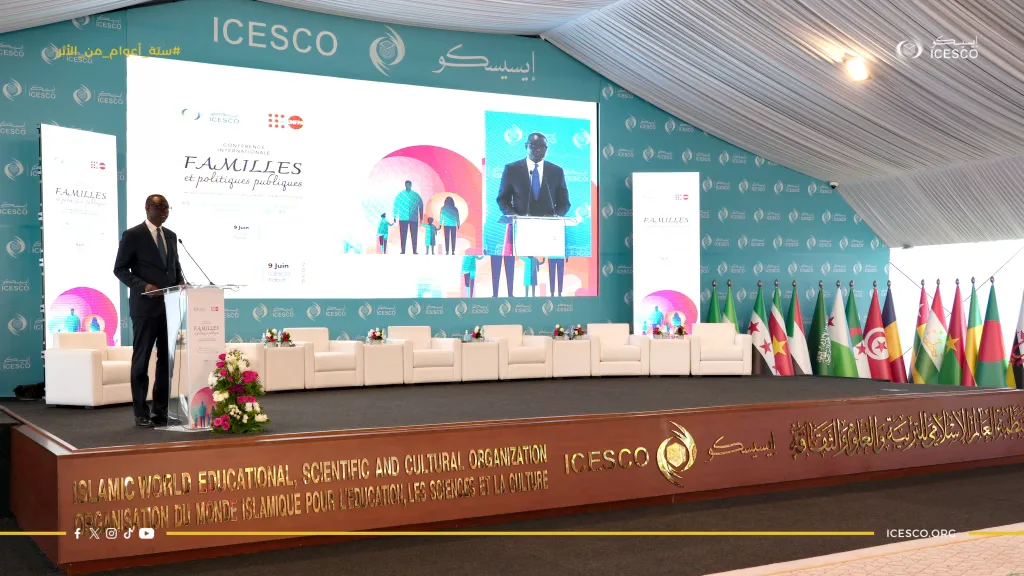 A speaker addresses the ICESCO Families and Public Policies conference from a podium before member-state flags.