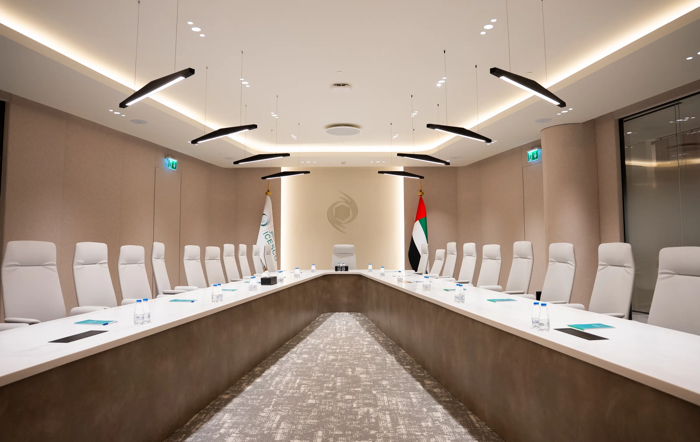 A U-shaped conference table faces ICESCO and UAE flags beneath an embossed organizational logo.